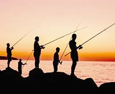 5 men fishing from shore sunset