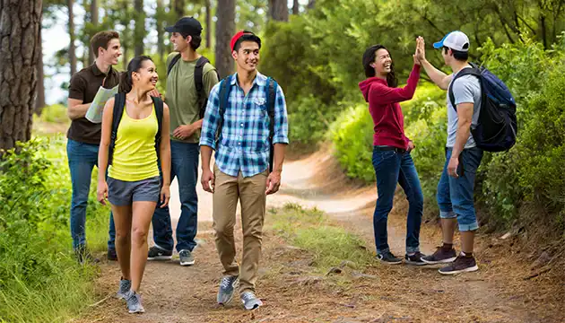 College students hiking along trail