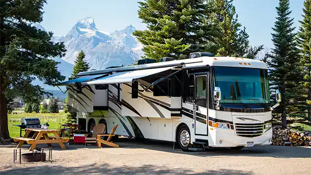 Class A RV parked at beautiful camp site