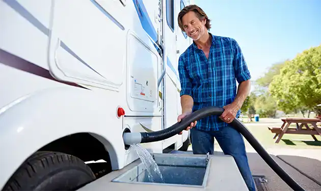 man doing rv waste water cleaning