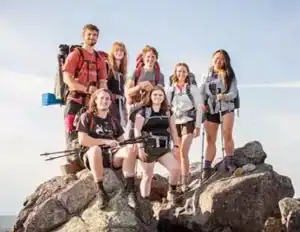 Hiking college students posing on top od rocky point