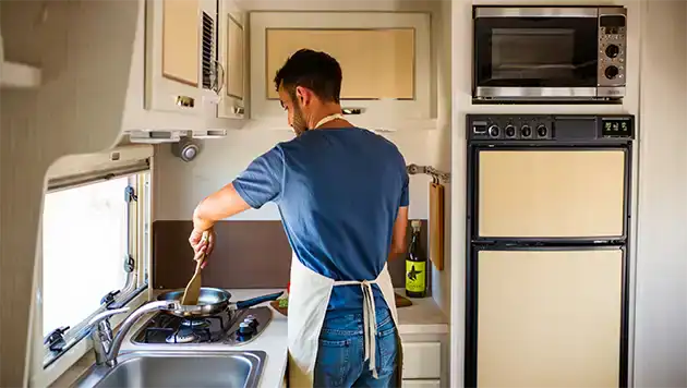 Man cooking in small rv 
