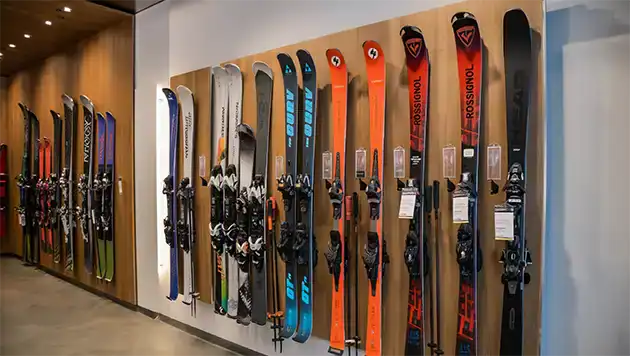 Store display hanging skis of many sizes and colors